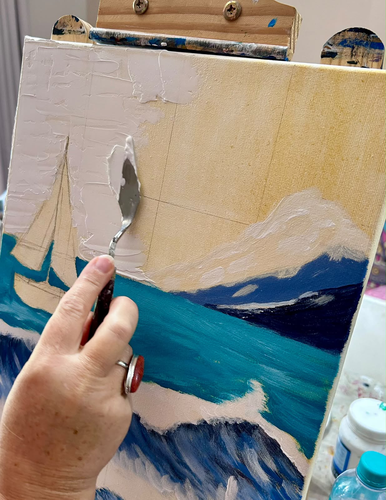 Palette knife sailboat seascape painting in progress on an easel